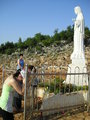 Praying before the statue of Our Lady statue at Podbrdo
